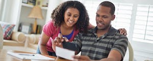 Father with daughter looking over finances and smiling